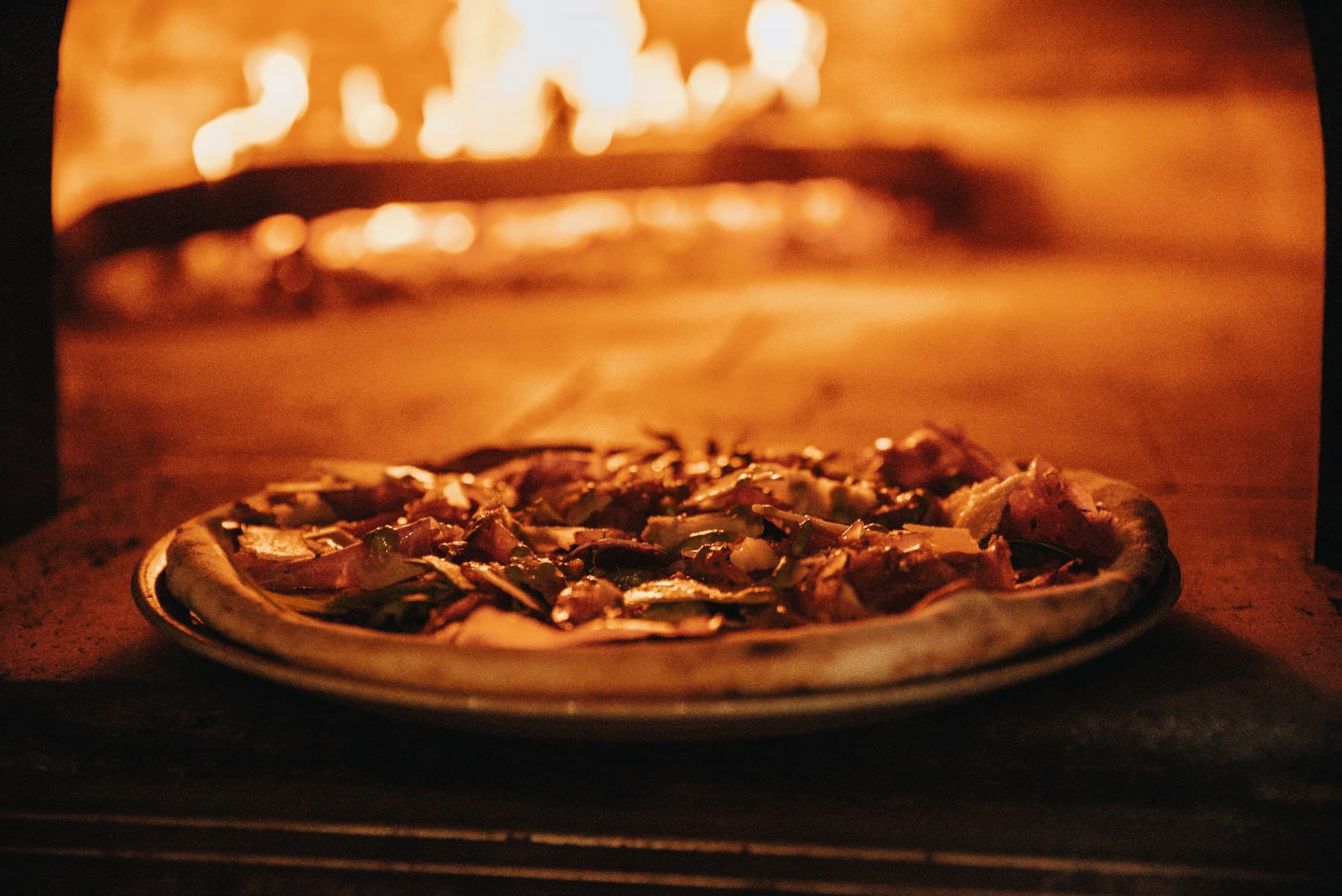 Wood-fired pizza oven with flames - authentic Italian oven at La Fornara in Naples
